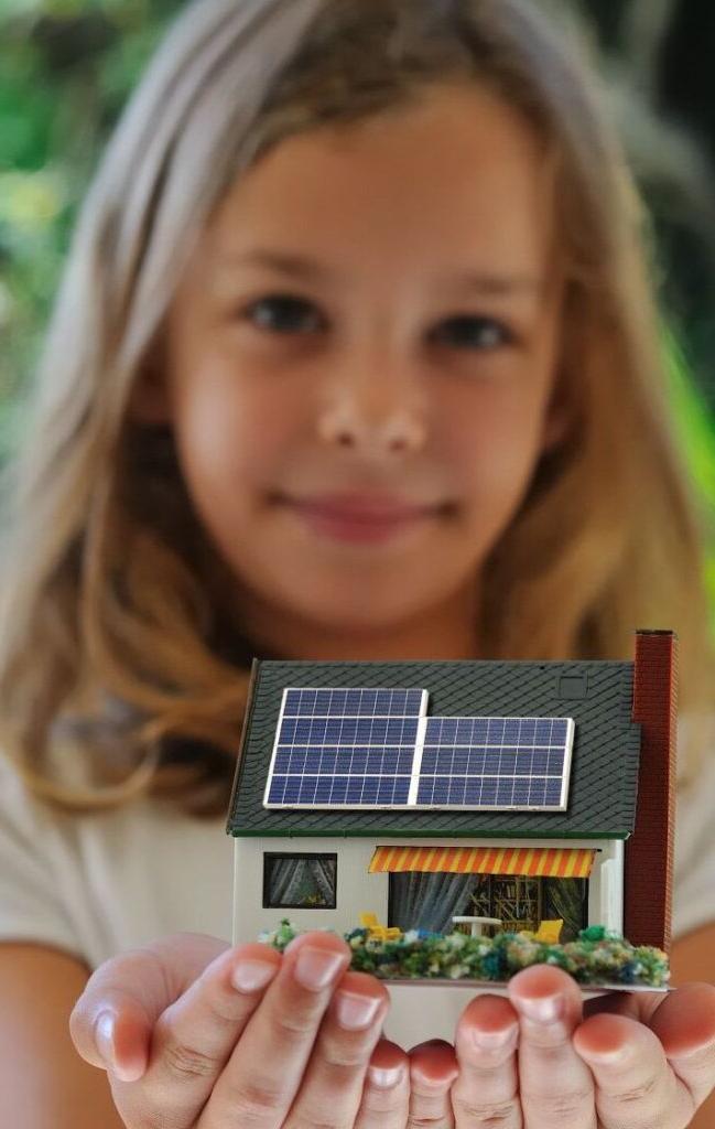girl holding house