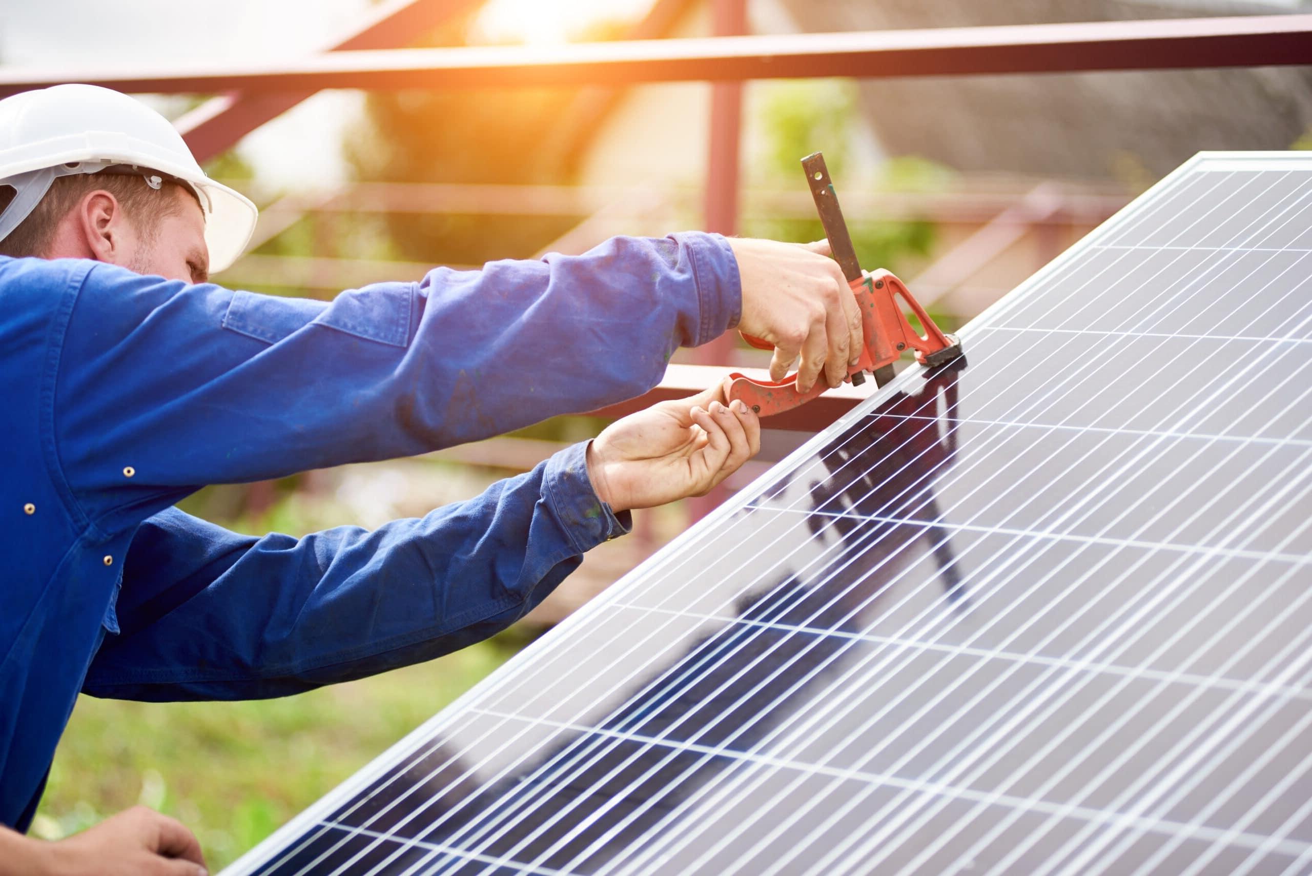 Installation of stand-alone exterior photo voltaic panels system. Renewable green energy generation.