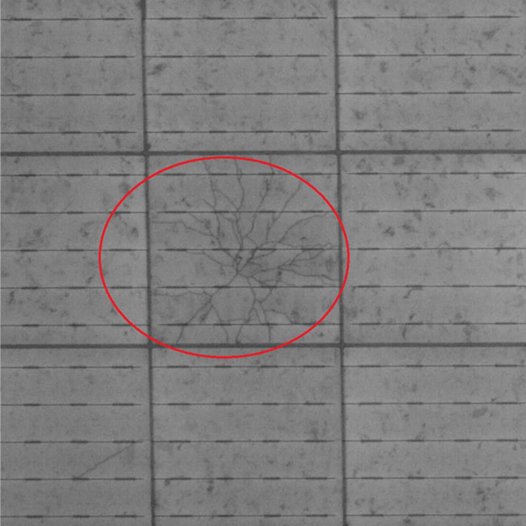 A red circle on the tile floor, indicating a crack in a solar panel.