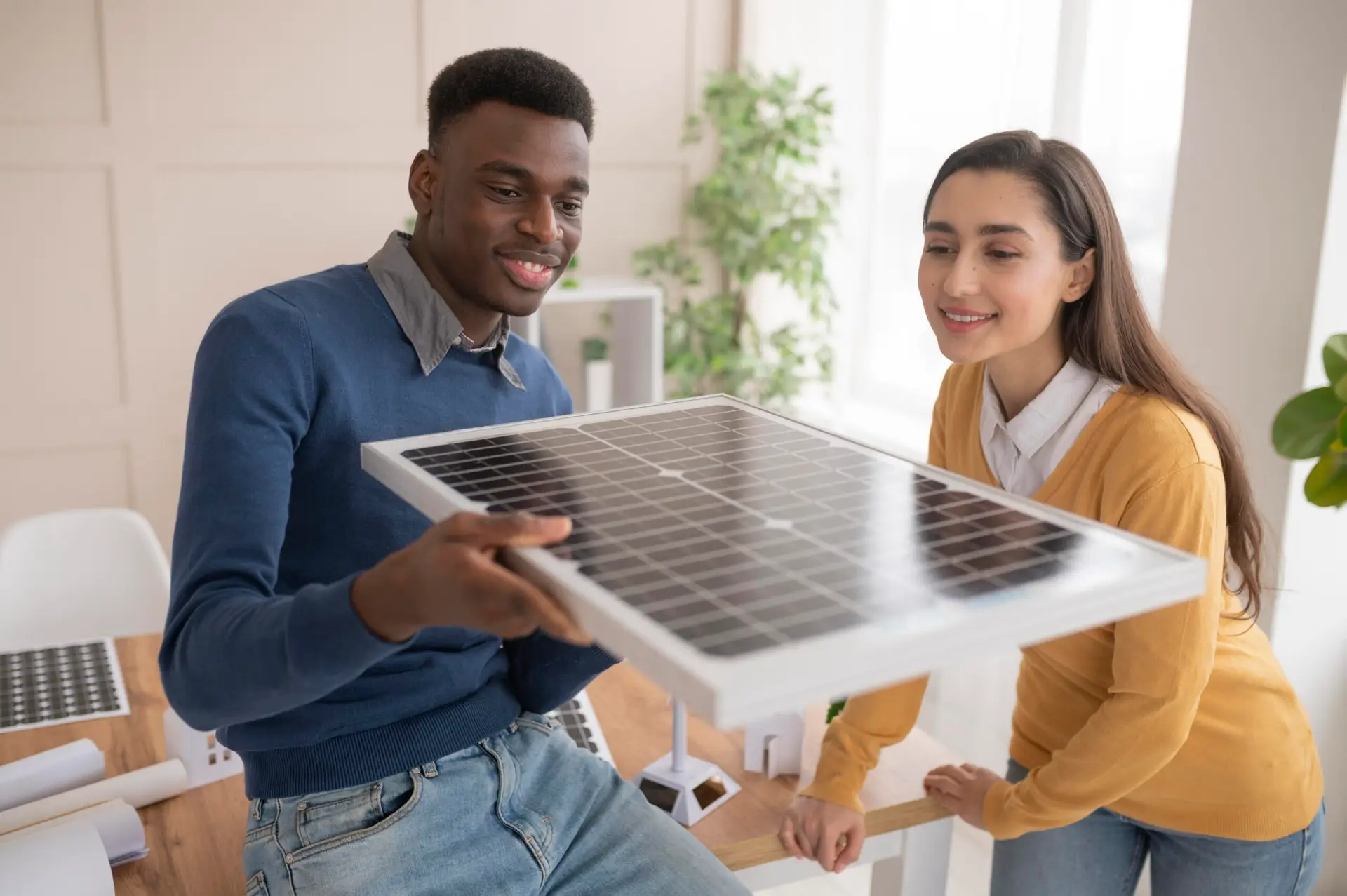 2 people holding a solar panel