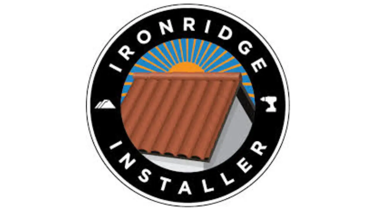 iron ridge logo in a circular black emblem surrounding a red tile roof with a sun shine in the background